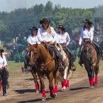 Members of the Austin Hick Chicks Precision Drill riding team make their way back to the barn after their grandstand performance.