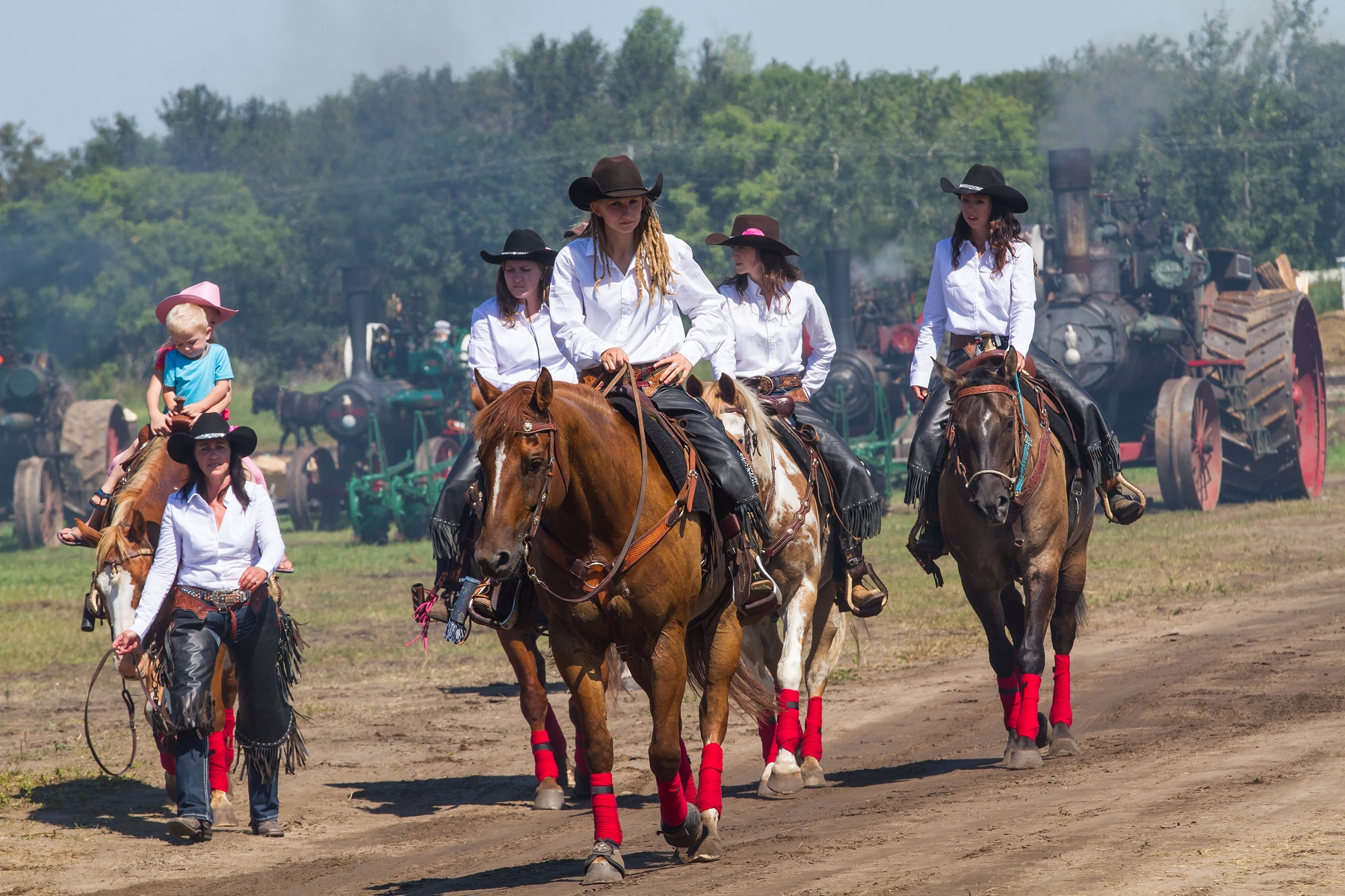 Members of the Austin Hick Chicks Precision Drill riding team make their way back to the barn after their grandstand performance.