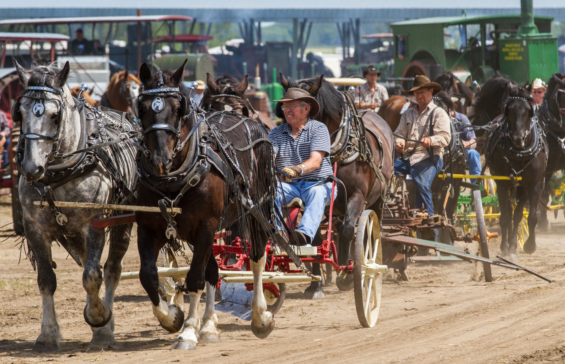 It all started with horses. Tractors line up as Ray Cook of Neepawa, Man. drives his sulky plow as the horse-powered portion makes it's way around the track.