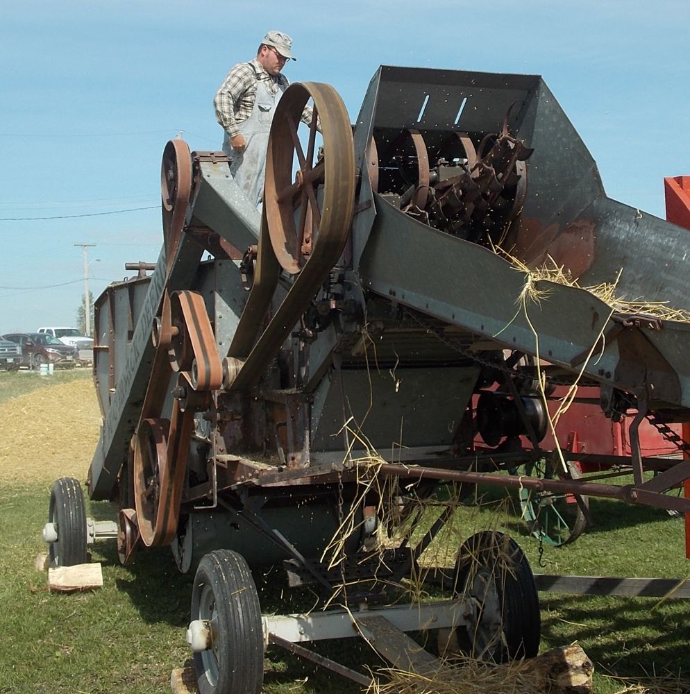 Ryan Down mans this 1952 McCormick Deering threshing machine.