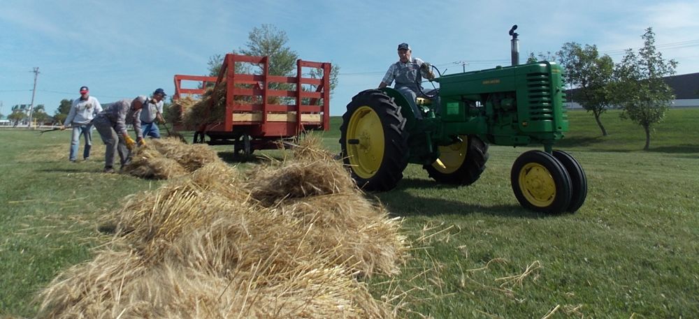 A 1951 Deere MT pulls the wagon.