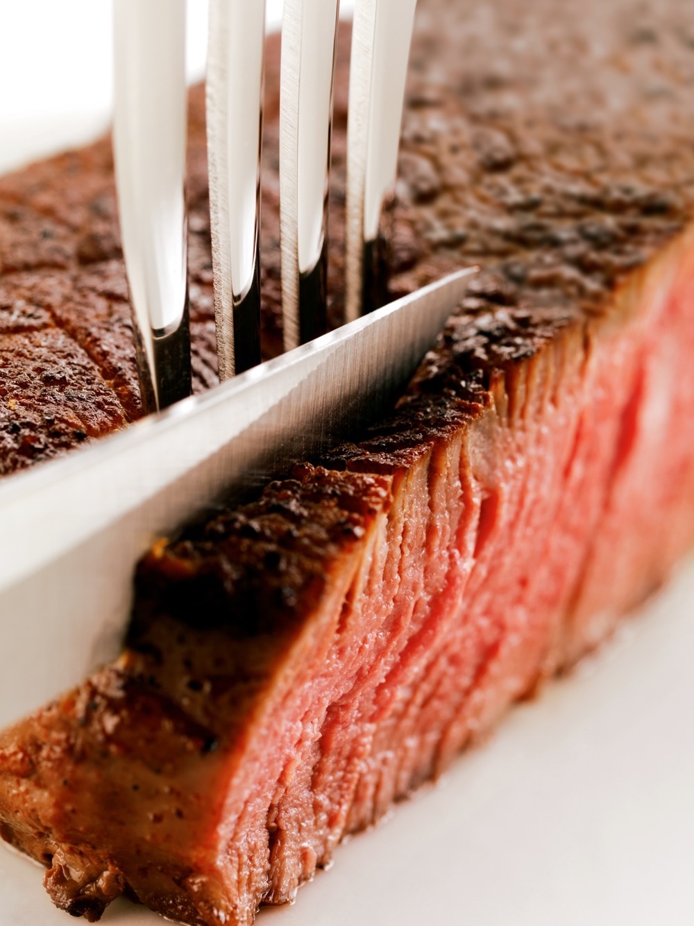 knife cutting into a steak