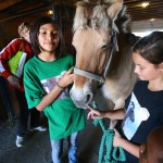 Winter Derange (left) and Maeve Partyka (right) show off Heather the pony to visitors at Aurora Farm. Nearly 40 farms participated in the annual event, which is in its sixth year.