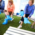 Visitors to Newest Poultry Farms Inc. don protective footwear on Open Farm Day.