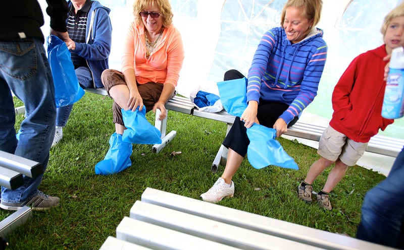 Visitors to Newest Poultry Farms Inc. don protective footwear on Open Farm Day.