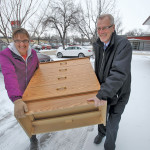 Ray Loewen and Annie Doerksen carry a donation into a former furniture store being used as a depot for household goods for Syrian refugees who will settle in Altona.