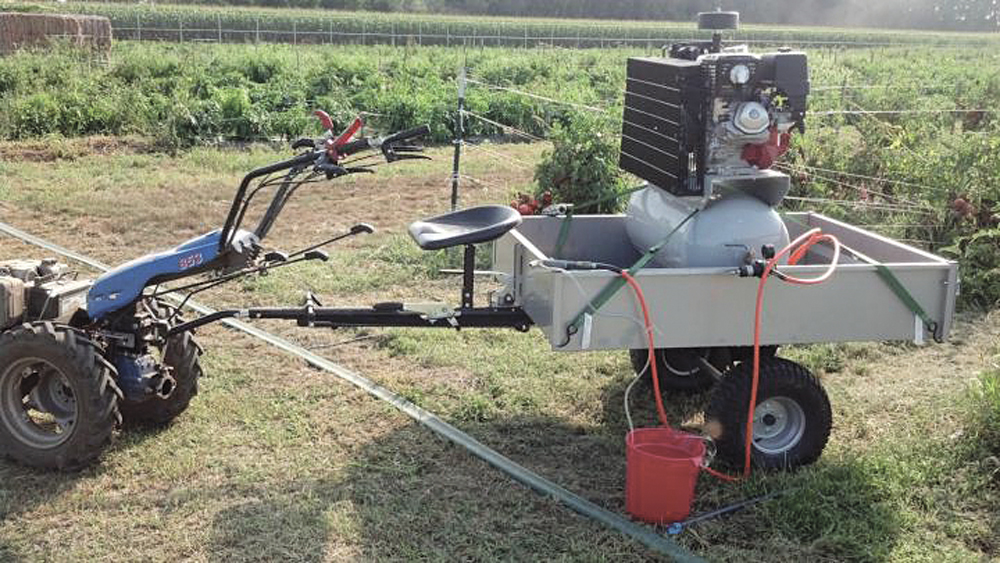 Hand-held weed-blasting unit used to control weeds in organic plots.