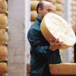 A worker opens a Parmesan cheese wheel at a warehouse owned by Credito Emiliano bank in Montecavolo, near Reggio Emila, central Italy.