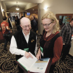 Brian Amiro and Karin Wittenberg look over their presentation at Crop Connect in Winnipeg.