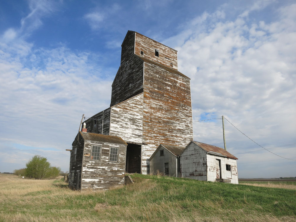 This grain elevator in the village of Oberon, on the CPR Varcoe Subdivision in the Municipality of North Cypress-Langford, was once operated by the Oberon Cooperative Elevator Association as part of the Manitoba Pool Elevators network. It now stands abandoned.