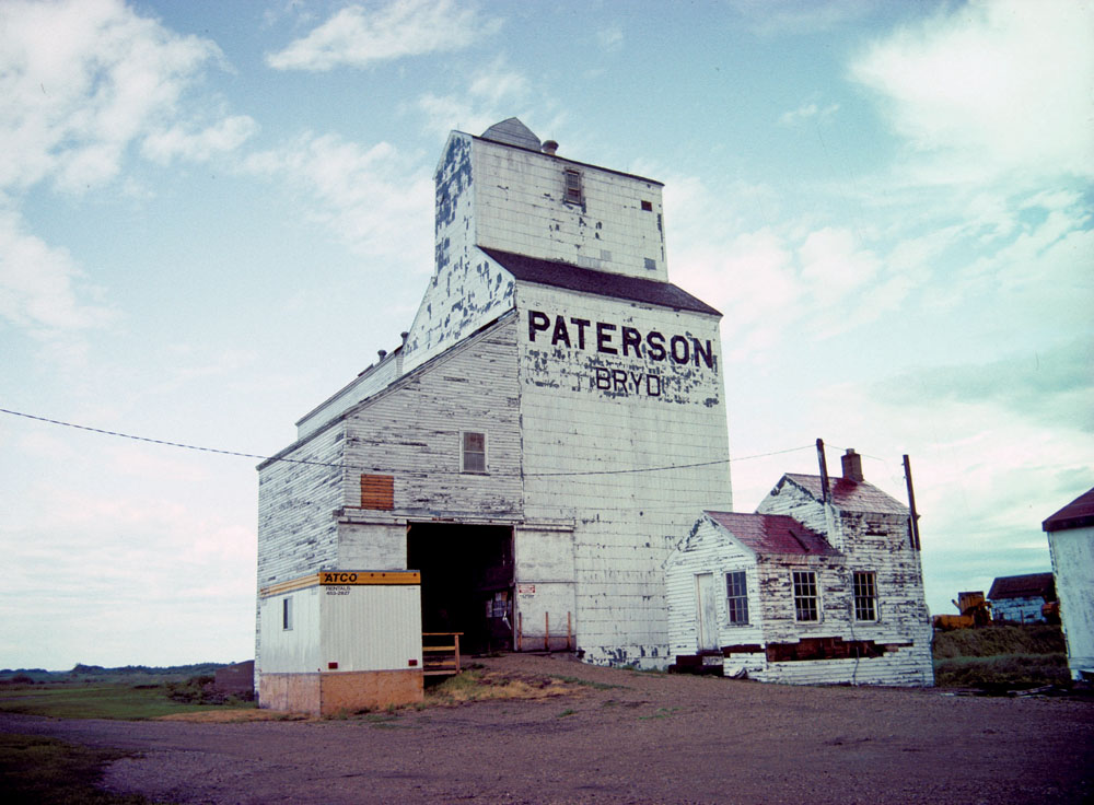 A grain elevator at the railway siding of Bryd, along Highway 16 in the Rural Municipality of Yellowhead, was constructed in 1914 by Smith Murphy. It was purchased by the Paterson Grain Company in 1926 and an annex was constructed in 1956. The elevator operated into the early 1990s when a provincial government report said there were “no plans to close it in the foreseeable future.” However, it closed in the fall of 1994, and the building was pushed over and burned in February 1996.   PHOTO: MANITOBA HISTORIC RESOURCES BRANDON (JULY 1993)
