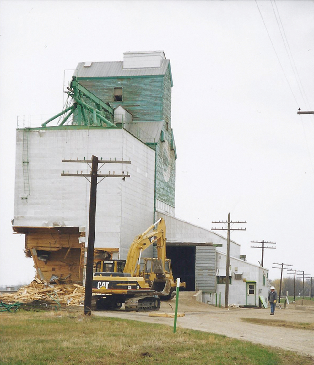The last grain elevator in Sidney was built by Reliance Grain in 1942. Having a capacity of 36,700 bushels, it was sold to Manitoba Pool in 1948. Traded to Cargill Grain in 1975, substantial renovations were made at that time. The elevator was demolished in 1999.  PHOTO: SANDRA REMPEL (1999)