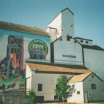 A Pool elevator and annex on South Railway Street in Boissevain features a large, colourful mural painted in the 1990s by artists Stephen Jackson and Gus Froese.