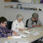Kathie Geekie (l to r), Reva Martin and Elaine Morton, are among volunteers  who fold and address the weekly edition.