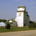An 87,000-bushel elevator, annex, and steel bins in Dominion City were built by Manitoba Pool in 1966. They were traded to United Grain Growers, whose nearby elevator had been demolished in 1990. The facility closed in January 1999 and was demolished. During its period, the local UGG board was active in the community, hosting an annual curling bonspiel, providing trophies for 4-H public speaking competitions, purchasing uniforms for local juvenile hockey teams, and making donations for the upkeep of the local rink.