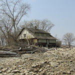 Mallard Lodge has been undermined by waves
and the windows are boarded up.