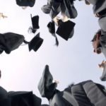 graduates throwing hats in the air