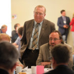 Agriculture Minister Ralph Eichler (standing) listens to stakeholder concerns during an industry consultation in Portage la Prairie.