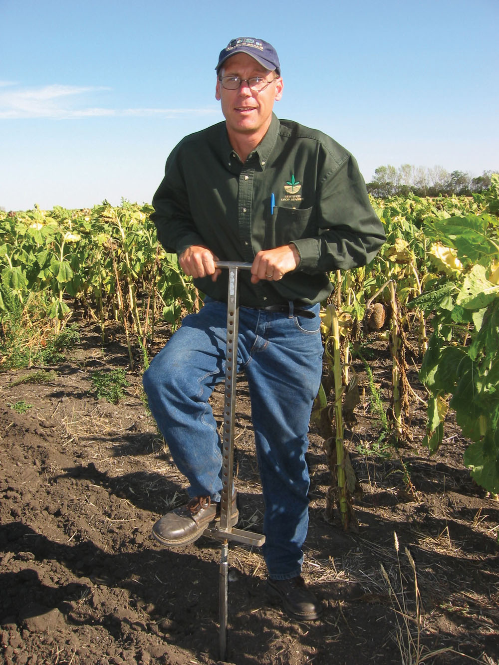 Manitoba Agriculture soil fertility specialist John Heard, soil sampling the old-fashioned way, says sampling cereals fields right after combining provides some advantages.