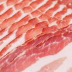 Fresh raw bacon slices close up image