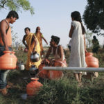 Residents wait to fill their containers with water in a field in Latur, India, April 17, 2016.