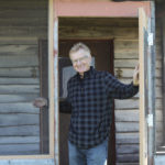 Martin Entz stands in the porch of a tiny clubhouse built so researchers and students could take shelter from the weather at the Glenlea Long-Term Study.