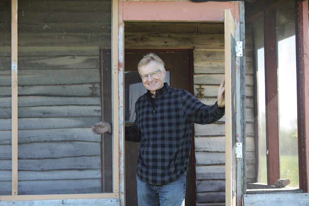 Martin Entz stands in the porch of a tiny clubhouse built so researchers and students could take shelter from the weather at the Glenlea Long-Term Study.