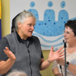 Anna Maendel (l) explaining the quilt project to Barb Pantel.