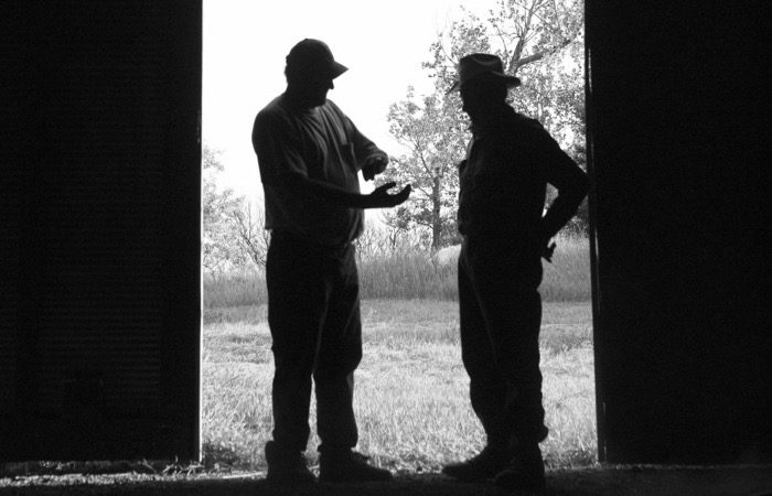 two men in doorway of barn