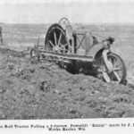 Canadian Bull tractor pulling a two-furrow, Powerlift “Enicar” made by J.I. Case Plow Works, Racine, Wis.