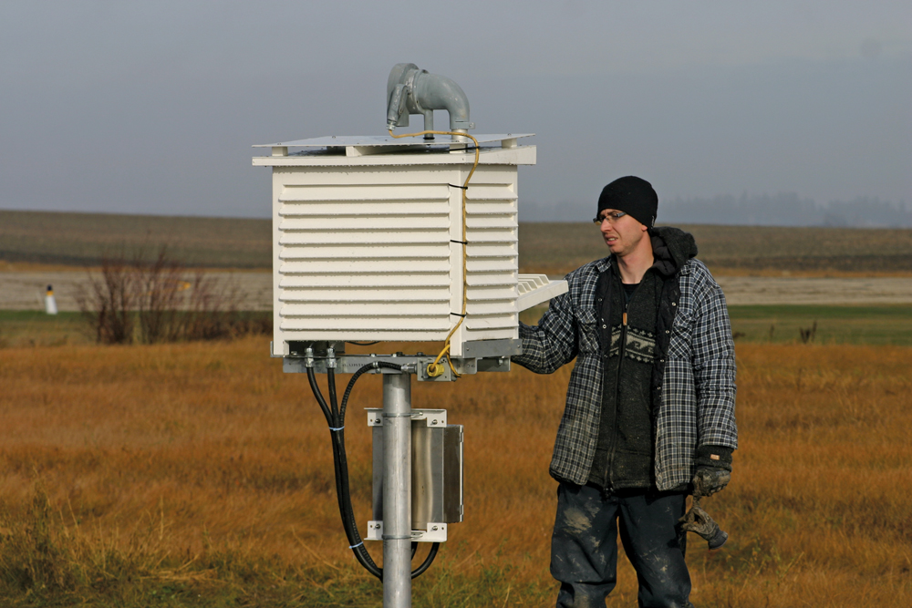 Nathon Kucherhan checks out a device known as Stevenson Screen, which includes temperature and humidity sensors.