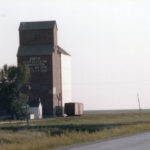 A wooden grain elevator at Smith Spur (probably named for grain executive Sidney T. Smith) along highway No. 23 east of Lowe Farm, in the Rural Municipality of Morris, was operated by the Reliance Grain Company until 1948, when it was sold to Manitoba Pool Elevators. An annex was built in 1967. Closed in 1984, the annex was moved to Morris in 1989.