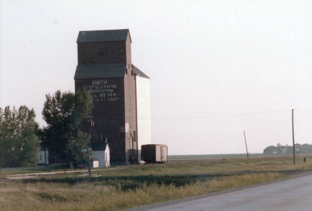 A wooden grain elevator at Smith Spur (probably named for grain executive Sidney T. Smith) along highway No. 23 east of Lowe Farm, in the  Rural Municipality of Morris, was operated by the Reliance Grain Company until 1948, when it was sold to Manitoba Pool Elevators. An annex was  built in 1967. Closed in 1984, the annex was moved to Morris in 1989.