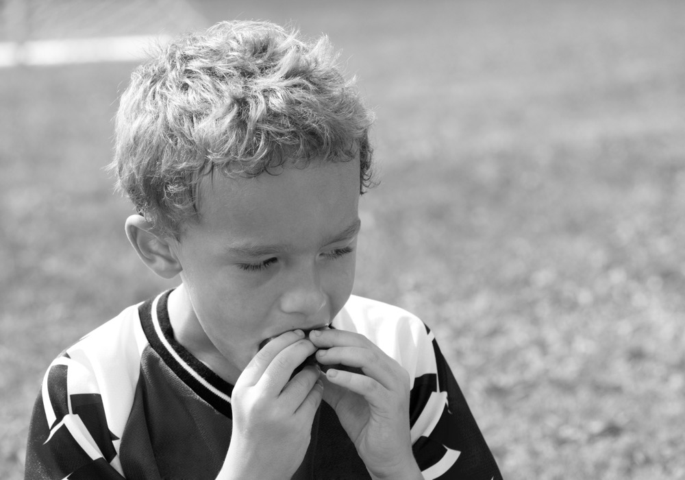 Young soccer player enjoying halftime snack