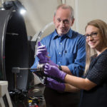 Rachel Parkinson (r) and Professor Jack Gray use a “video game” to study pesticide effects on insects.