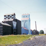 The UGG elevator at Kane, seen in this 1960 photo shortly after its purchase from the Canadian Consolidated Grain Company, closed in May 1996 and was demolished in August 1996. The Paterson elevator, built in late 1947 to replace one destroyed by fire earlier that year, still stands although its two annexes were replaced by a new elevator built in 1982. The railway spur was removed in 2007 but the elevator is used by local farmers for their own grain storage.