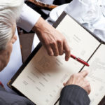 man reading a restaurant menu