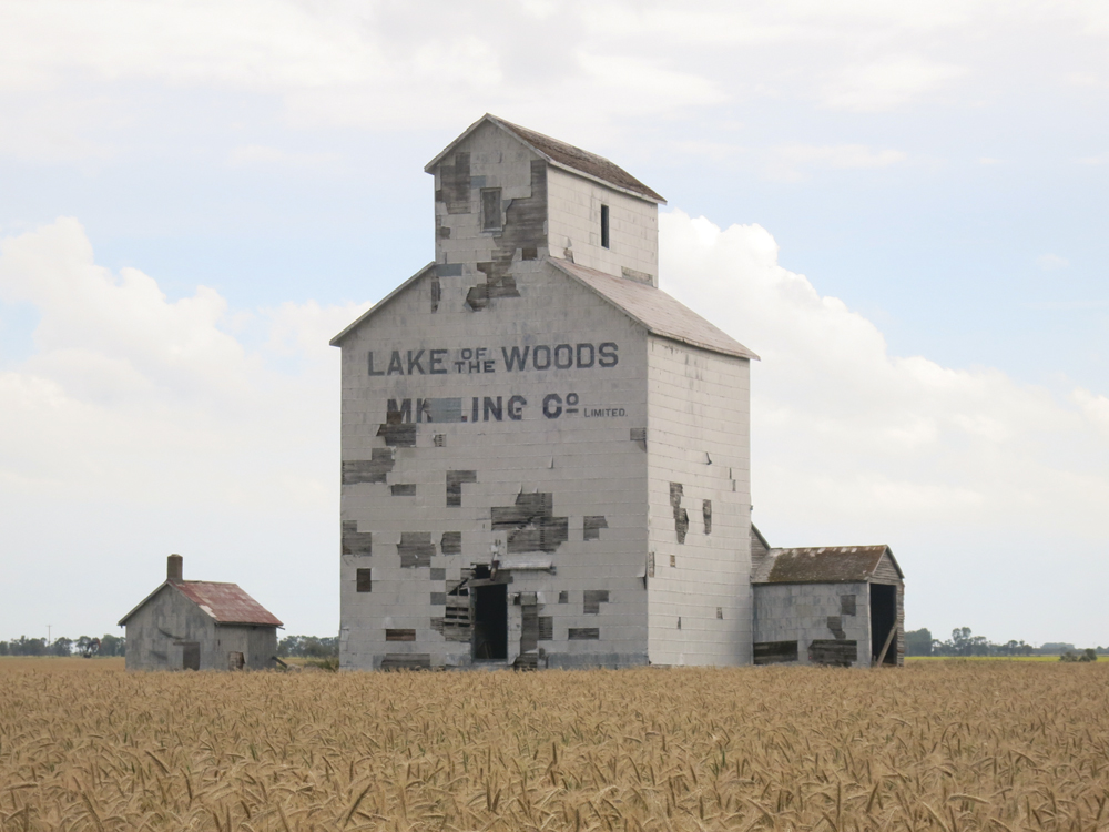 A grain elevator at the former CPR railway siding of Cameron (named for Melita implements dealer A. E. Cameron, in the RM of Two Borders, was built by the Lake of the Woods Milling Company sometime between 1902 and 1910. It became part of Ogilvie Milling after the two companies merged in 1954 and was purchased by Manitoba Pool in 1959. The 38,000-bushel elevator was closed around 1970 and sold into private hands. It now stands abandoned, surrounded by cropland.