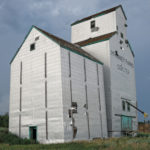 A 50,000-bushel grain elevator at Coulter, on the CPR Lyleton  Subdivision in the RM of Two Borders, with its associated crib annex and  engine shed, was once operated by Manitoba Pool. Built in 1928, it  closed in July 1971. Rail service ceased when a bridge was washed out  during a severe storm and was not replaced. The elevator was purchased  by a local farmer and used for private grain storage. This photo was  taken in July 2016.