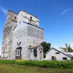 The shorter of two elevators in Isabella, in the RM of Prairie View, was built in 1910 by the Western Canada Flour Milling Company and sold to Manitoba Pool in 1939. The taller elevator was constructed in 1913 by the Grain Growers’ Grain Company (later UGG) and operated until 1962 when it was traded to the Pool. The elevators were some distance apart but Pool moved the former UGG elevator next to its elevator and built a common driveshed between them. They closed in December 1978 as the adjacent CNR line was abandoned. Sold to a local farmer and used for grain storage into the 1990s, they are now in poor structural condition.
