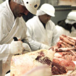 Workers bone and cut beef at a meat packing plant in Toronto, May 22, 2003. Work continues at the plant despite several countries placing a temporary ban on Canadian beef after a case of Mad Cow disease was discovered on an Alberta farm.