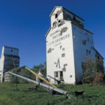 Two grain elevators at the former railway siding of Barnsley, in the RM of Dufferin north of Carman, were once operated by Manitoba Pool. “Pool B” (right) was constructed before 1916 by the provincial government as one of about 40 it built between 1910 and 1923 under the auspices of its Manitoba Elevator Commission. The elevator was leased to United Grain Growers in 1916 and sold to the Pool around 1959, which built “Pool A” (left) in 1928. The two elevators were closed in July 1972 and sold to a local farmer. Both are now in poor structural condition.