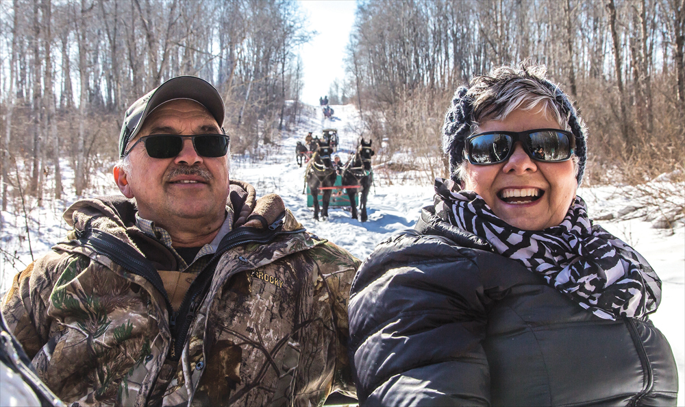 David and Marnee Bonchak of Solsgirth enjoy the view from the back of  Jim Lane’s sleigh, out of Birtle.