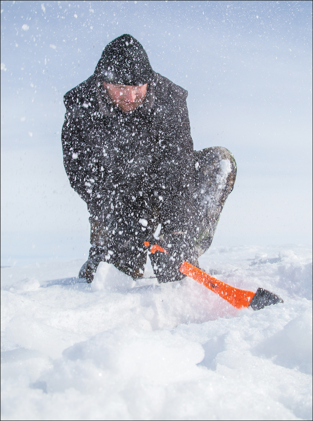 Derek Huston of Rivers widens his fishing hole, no small feat with ice measuring up to 37 inches thick in spots.