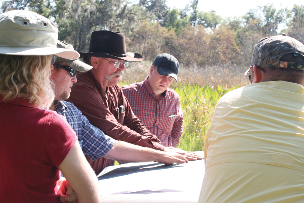 Taking a bit of time to create a grazing plan will pay good dividends for years, says rangeland specialist Pete Deal (centre in cowboy hat). 