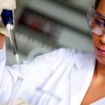 female scientist pouring liquid in a tube