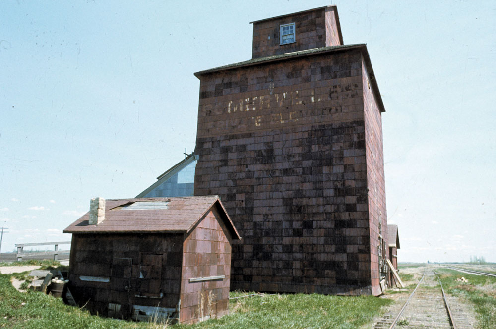 A small wooden elevator at the railway siding of Argue, southeast of  Hartney on the long-abandoned CNR Hartney Subdivision, was built around  1918 by the Ogilvie Flour Mills Company. Closed in 1946, the elevator  was sold and used for private grain storage by Somerville Brothers Farms  from 1951 to 1965. It was still standing at the site as recently as the  mid-1990s.