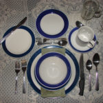 A formal table setting may include a lineup of utensils and glasses.