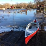 A canoe is now the mode of transport to reach the barn in this farmyard in Carman.