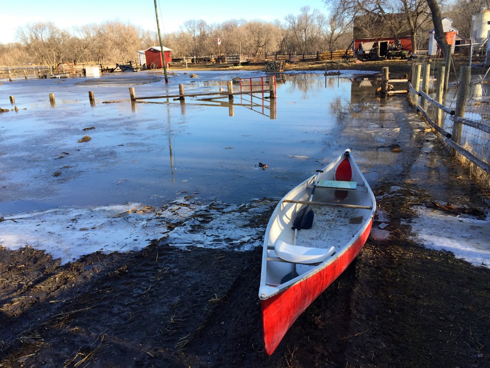 A canoe is now the mode of transport to reach the barn in this farmyard in Carman.
